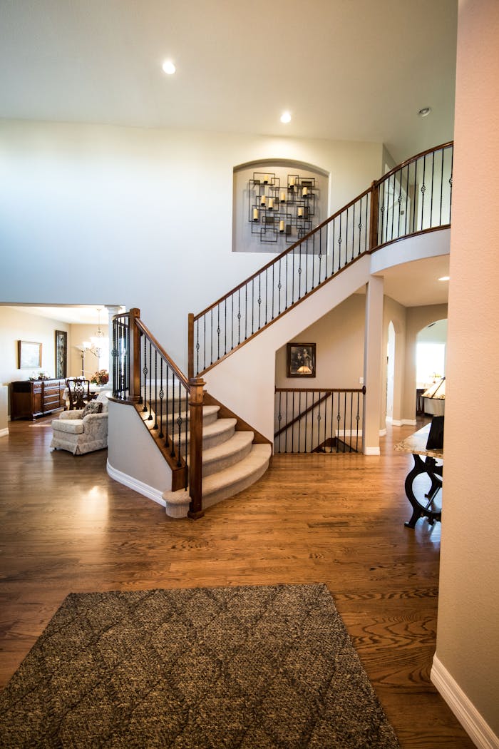 gallery-5 Spacious modern interior showcasing a stylish wooden staircase and elegant decor.